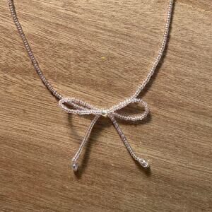 Bow necklace reminds me of Kara Yoo & Sandy Liang